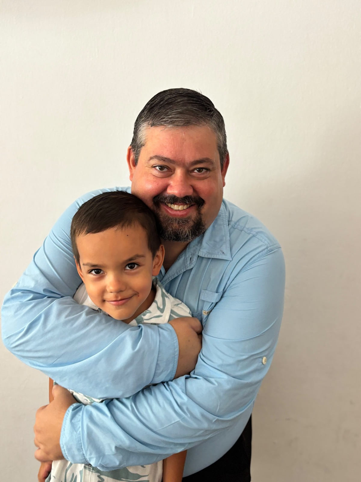 A father and son sharing a hug in Colombia