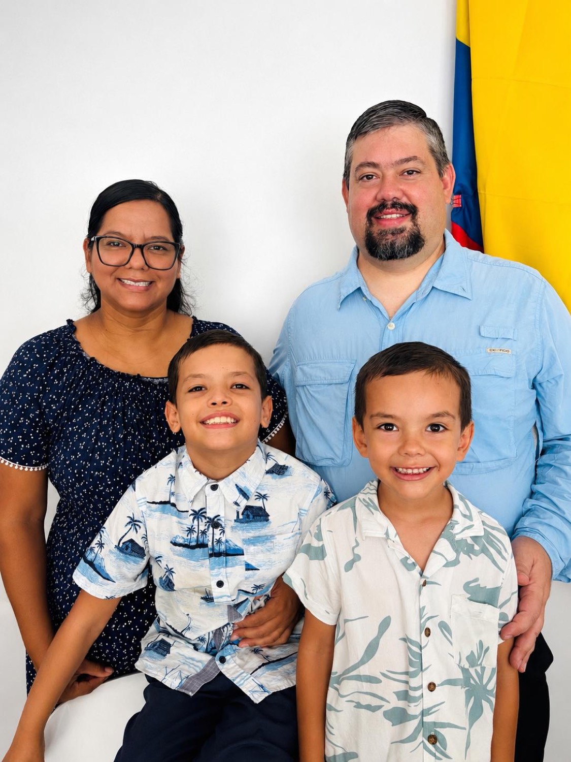 Ryan, Claudia, Levi, and Neal Goodall — a family portrait in front of the Colombian flag