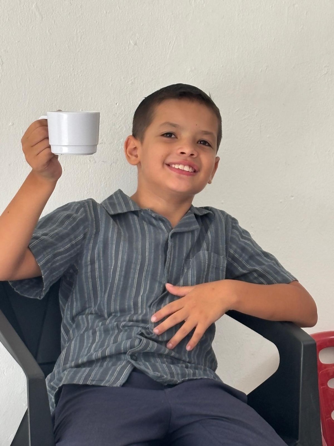 Levi laughing over a cup of coffee